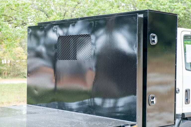 Flatbed truck with vented storage box